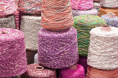 Coils and spools of colored wool thread for the creation of handmade sweaters