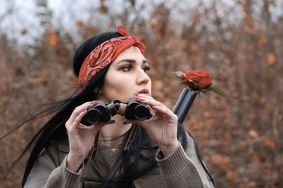 Portrait of beautiful woman holding autumn leaves