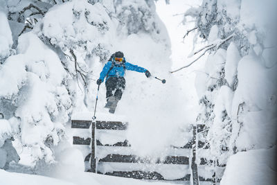 Man skiing on snow covered land