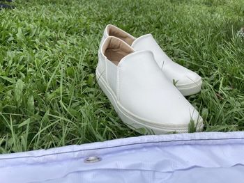 Low section of white shoes on field