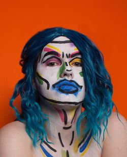 Portrait of young woman with multi colored background