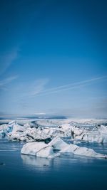 Scenic view of frozen landscape against sky