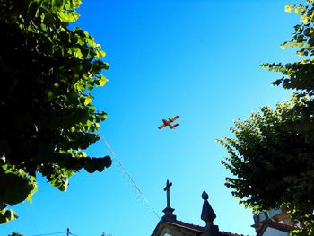 Low angle view of airplane flying in sky
