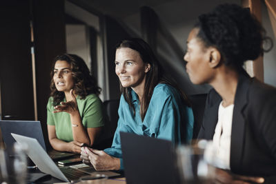 Multiracial businesswomen planning strategy during meeting at office