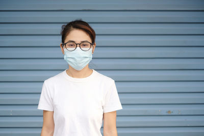 Portrait of mid adult man standing against wall