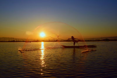 Man throwing fishing net in the sea