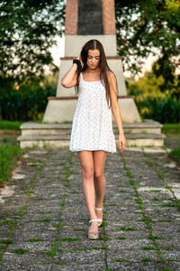 Young woman standing on footpath