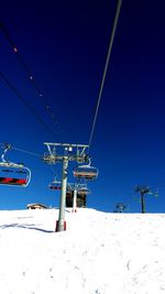 Low angle view of ski lift against clear sky
