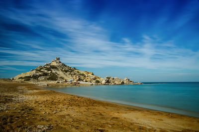 View of beach against cloudy sky