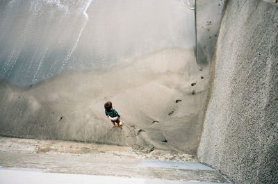 High angle view of man surfing on shore