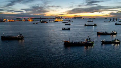 Boats in sea during sunset