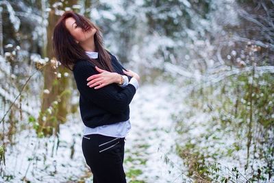 Side view of a young woman in forest