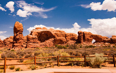 Rock formations on landscape against cloudy sky
