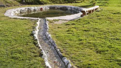 High angle view of stream flowing on field