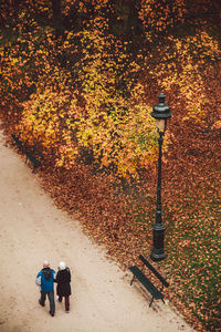 Rear view of man walking on footpath