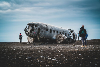 People standing on abandoned airplane