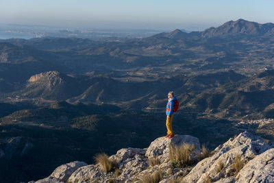 A woman hiking in the high country, costa blanca, el divino mountain.