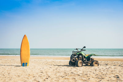 Deck chairs on beach against clear sky