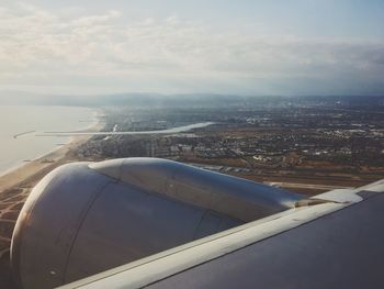 Cropped image of airplane over sea