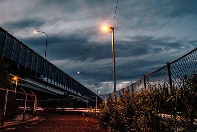 Illuminated bridge against sky at night