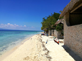 Scenic view of beach against blue sky