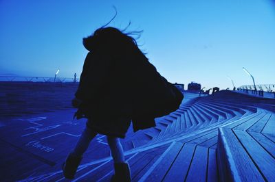 Rear view of woman standing in water