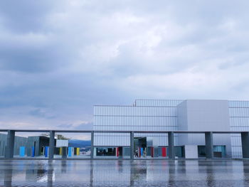 Reflection of building in swimming pool against sky