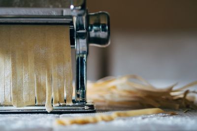 Close-up of pasta maker on table