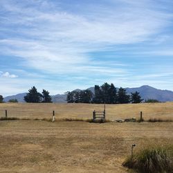 Scenic view of landscape against cloudy sky