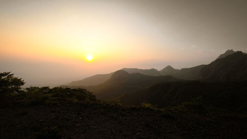 Scenic view of mountains against sky during sunset