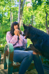 Woman sitting on seat in park