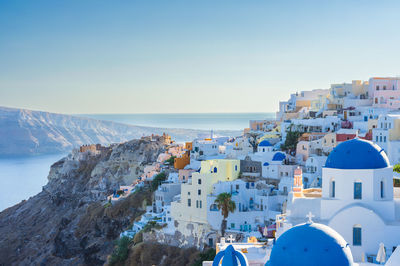 High angle view of santorini, oia townscape by sea against sky. cyclades, greek islands, greece