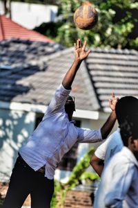 Teenage boys playing volleyball