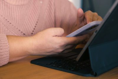 Midsection of man using laptop