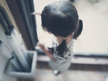 Rear view of girl sitting on camera