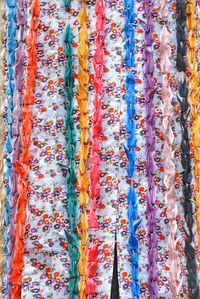Colorful paper cranes hanging by wall during traditional festival