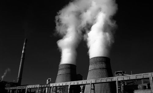 Smoke emerging from chimney against the sky