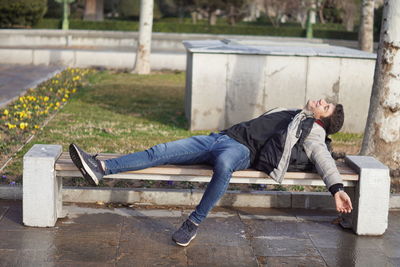 Side view of young man using mobile phone