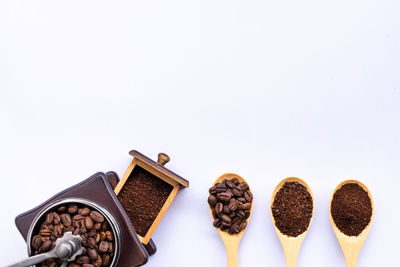 High angle view of coffee beans against white background