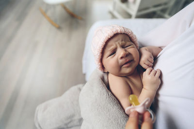 Cute baby girl lying down on bed