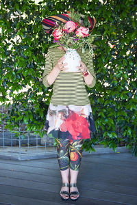 Full length of girl standing by pink flower tree