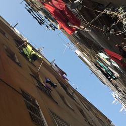 Low angle view of clothes hanging against clear sky