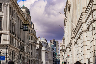 Low angle view of buildings against cloudy sky