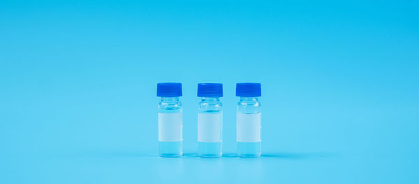 Close-up of vials against blue background