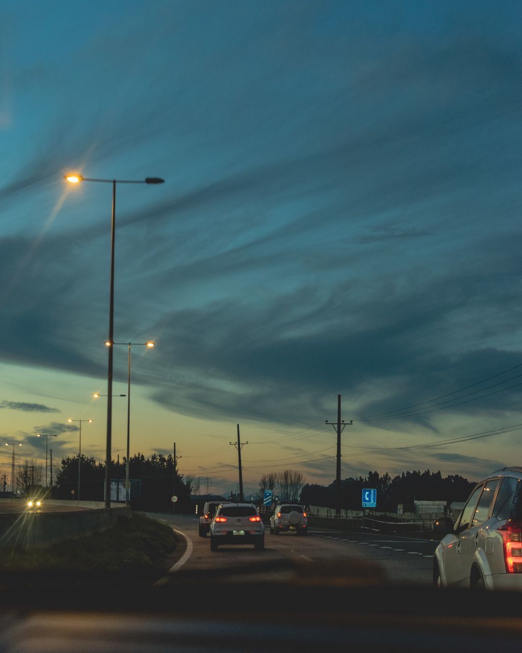 CARS ON ROAD AT DUSK