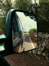 Reflection of car on side-view mirror