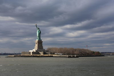 Statue of liberty against cloudy sky