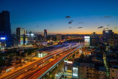 High angle view of illuminated buildings in city at night