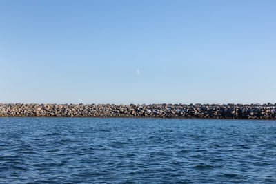 Scenic view of sea against clear blue sky