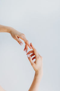 Close-up of woman hand against white background